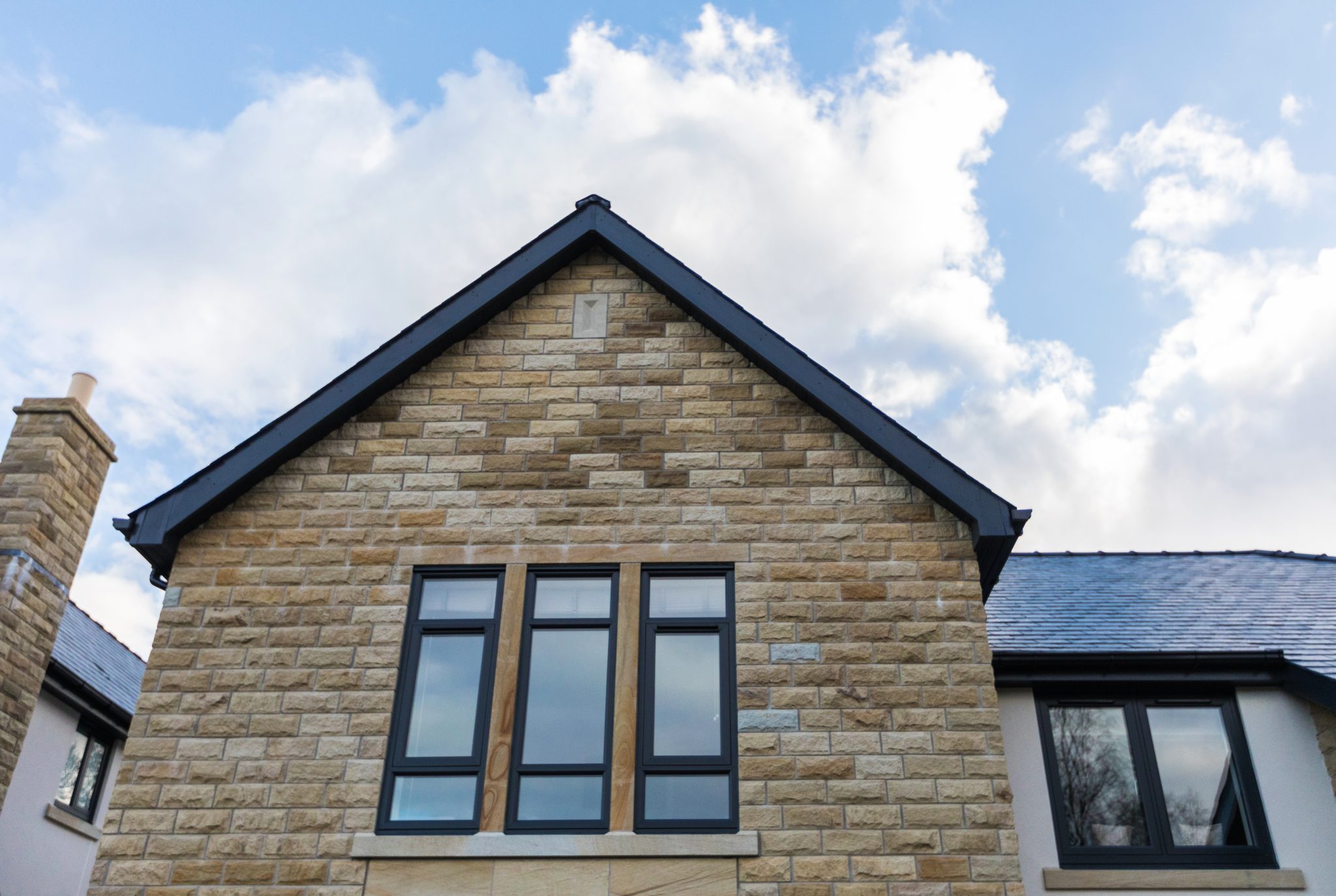 Anthracite grey flush fit PVCu windows installed on a stone built new build home in Derbyshire