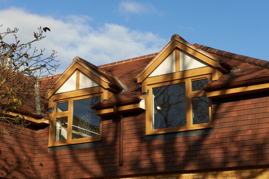 Irish oak woodgrain flush fit PVCu casement windows installed on a dormer home in Derbyshire