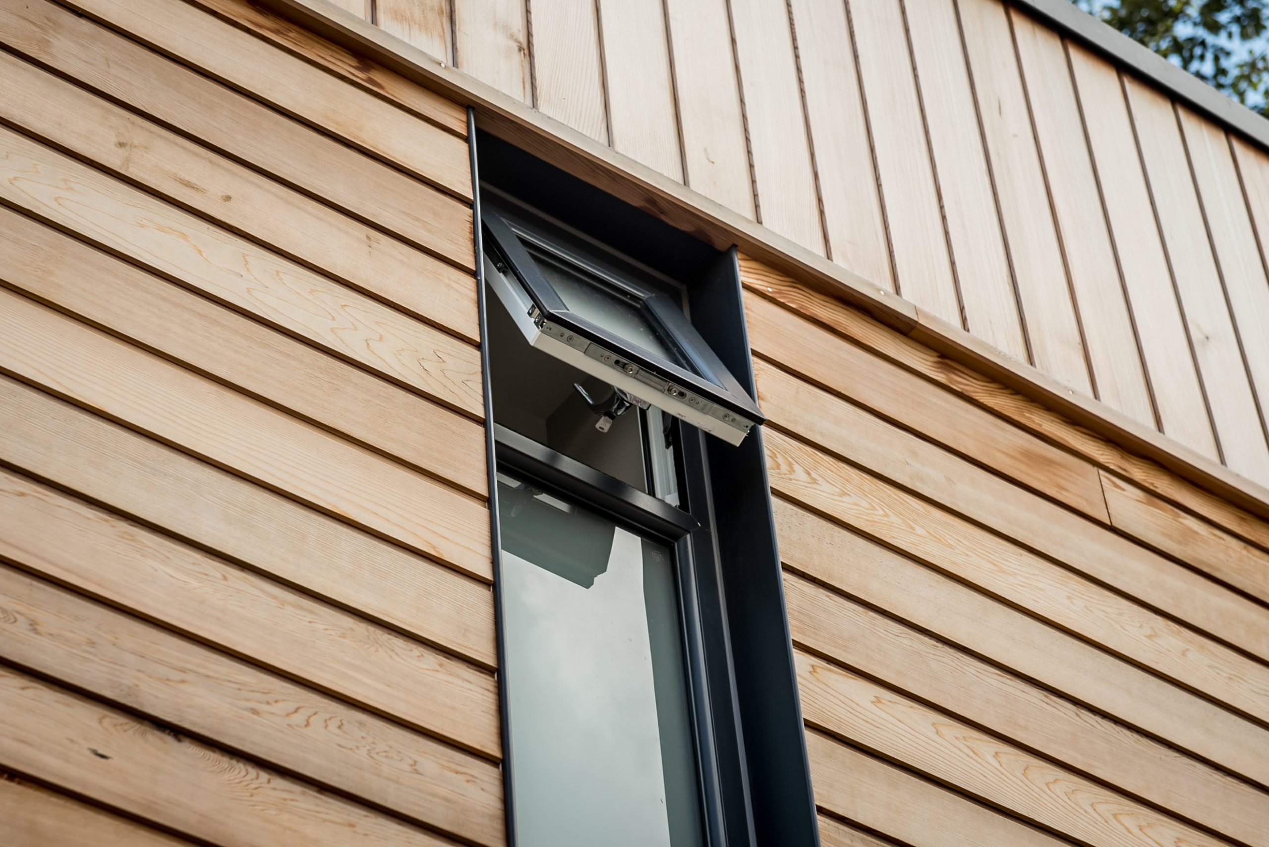 Anthracite grey flush fit PVCu casement window fitted on a timber clad home in Derbyshire