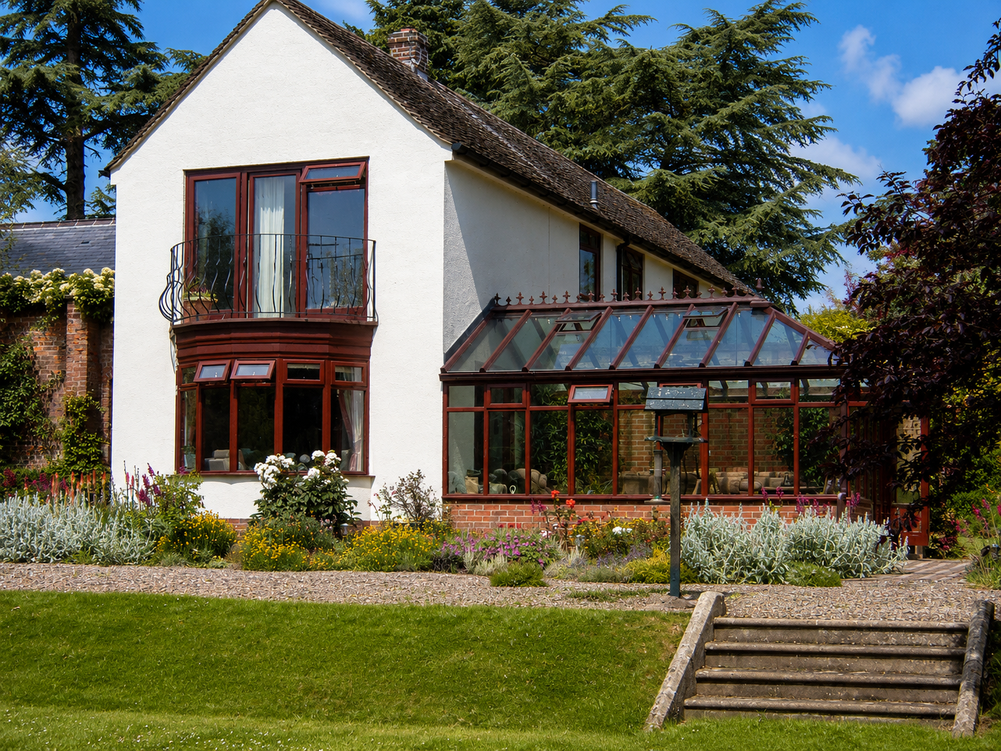 Hardwood windows and bespoke conservatory installed on a traditional white family home