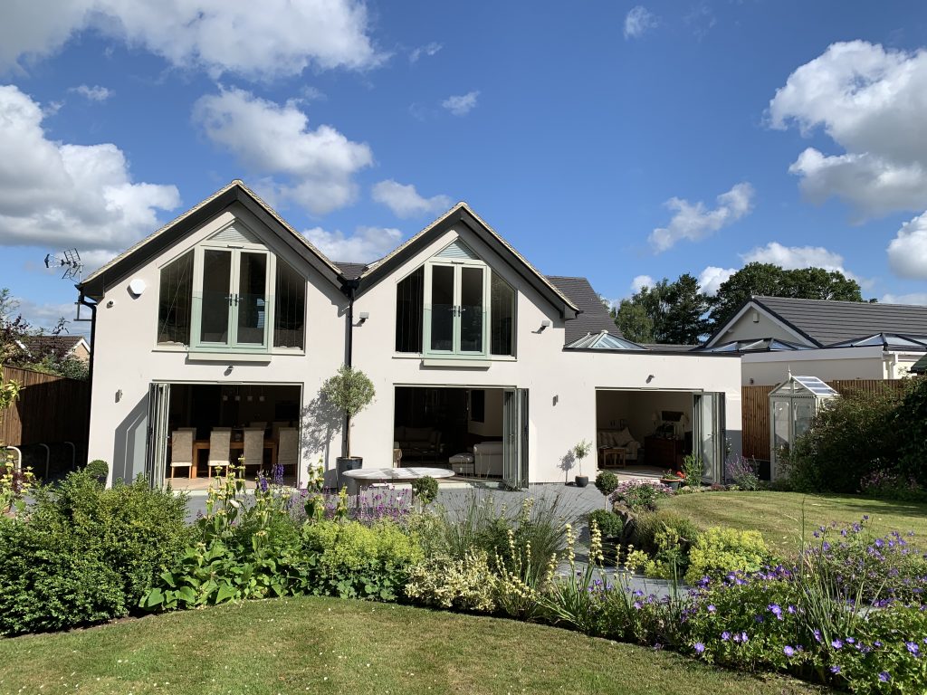 Sage green aluminium bi-fold doors and apex windows on a modern extension, Derby