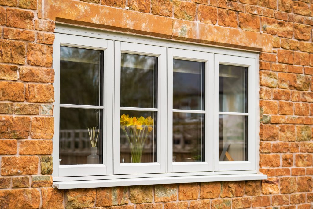 Agate grey flush fit PVCu casement windows installed on a traditional brick home in Derbyshire