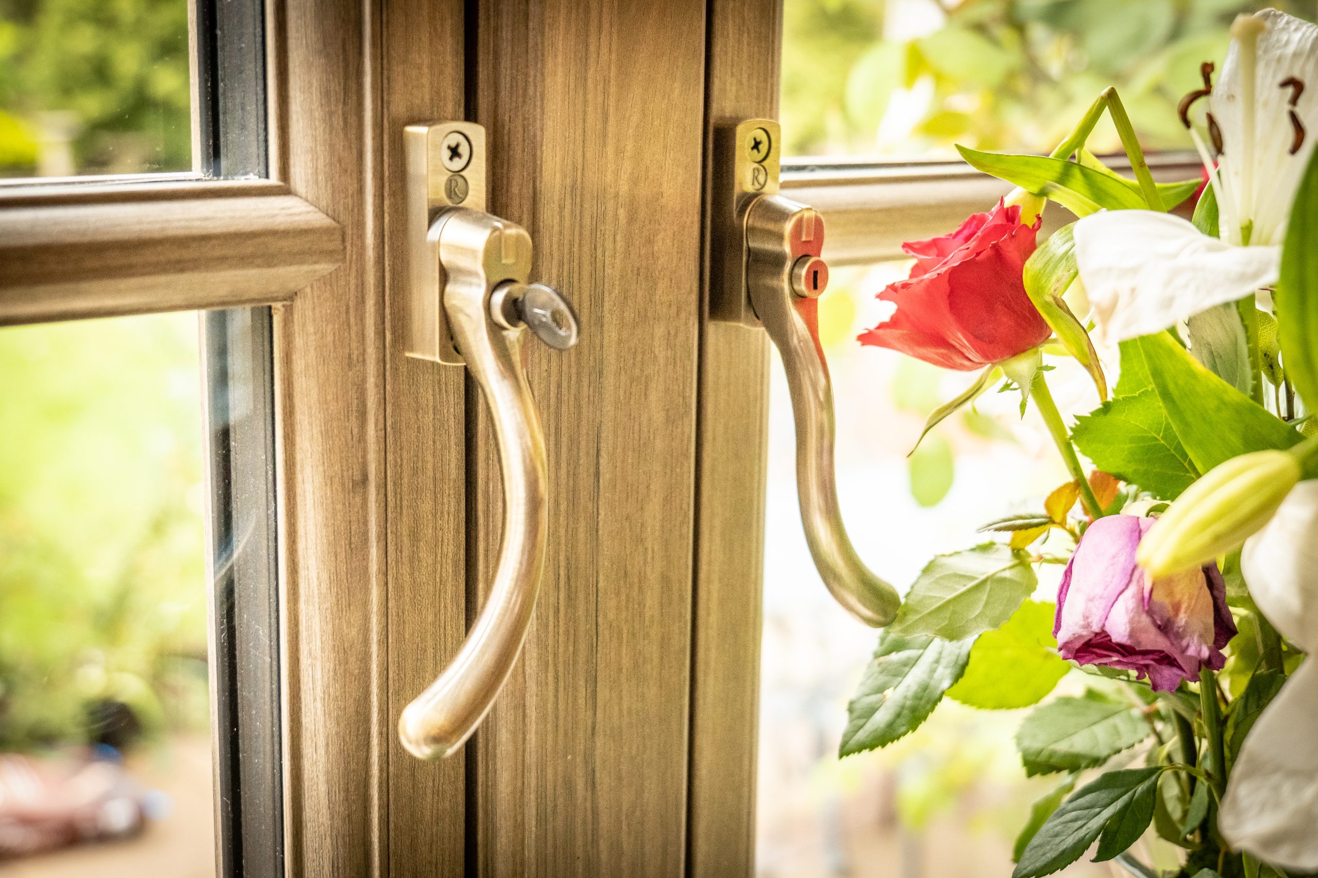 Anteak woodgrain flush fit PVCu window handle and locking detail Derby