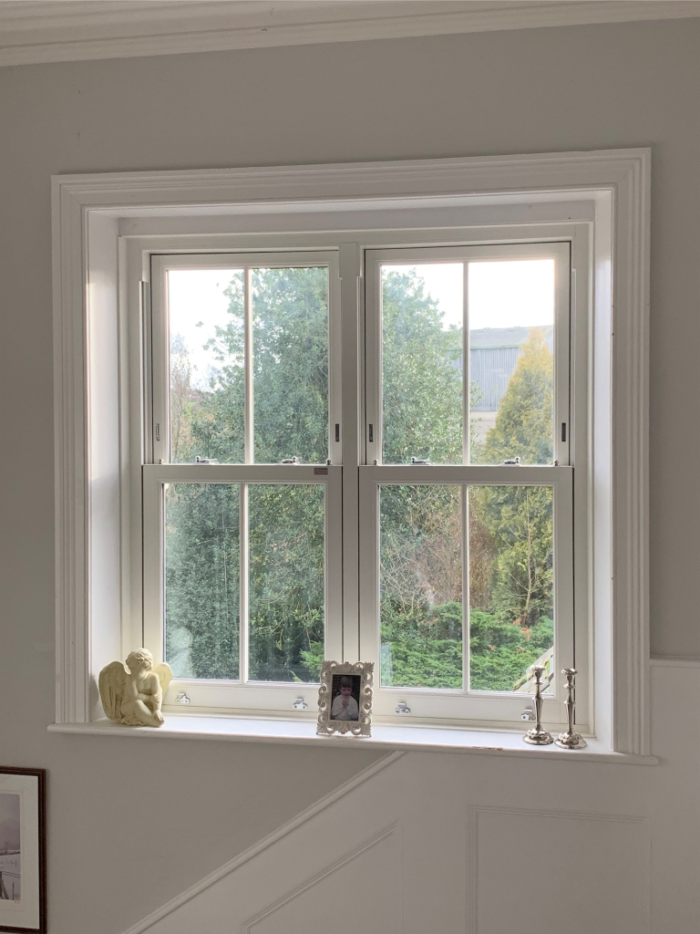 Interior view of white PVCu sliding sash windows Derby