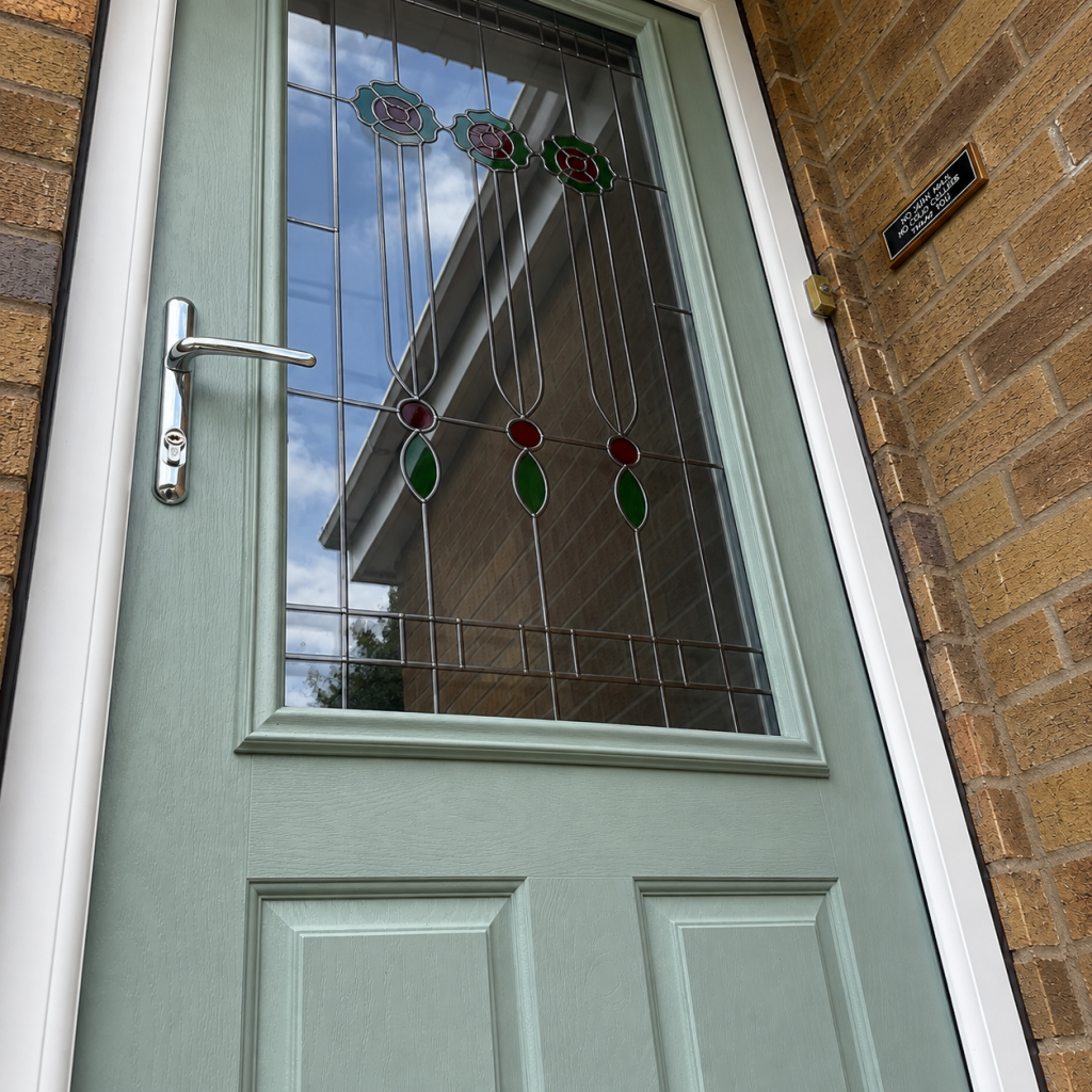 Bespoke glass design in a sage green front door with decorative leaded glass detailing.