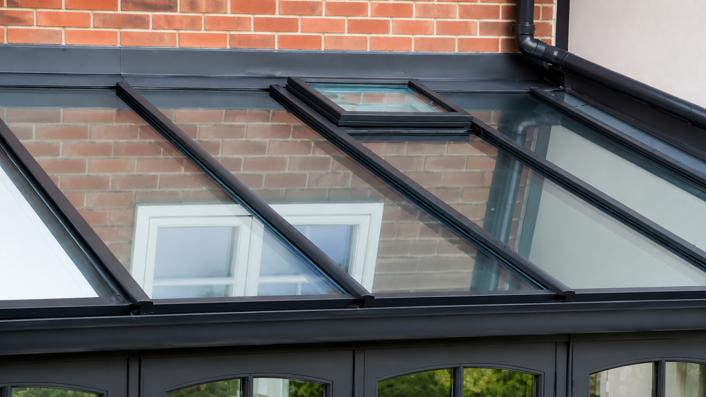 Modern glazed conservatory roof with slimline aluminium frames and high-performance glass panels, designed to maximise natural light and provide a sleek contemporary finish.