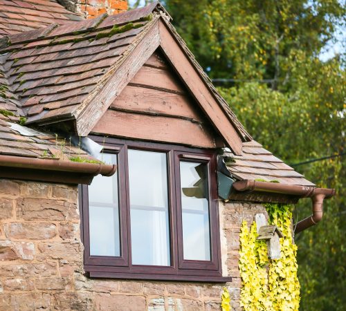 Rosewood flush fit PVCu casement windows installed on a traditional stone cottage in Derbyshire