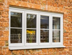 Agate grey flush fit PVCu casement windows installed on a traditional brick home in Derbyshire